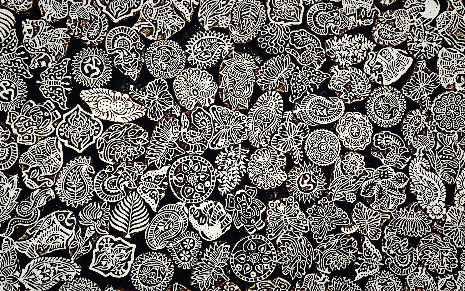 Carved wooden printing blocks with intricate floral and paisley patterns arranged closely together